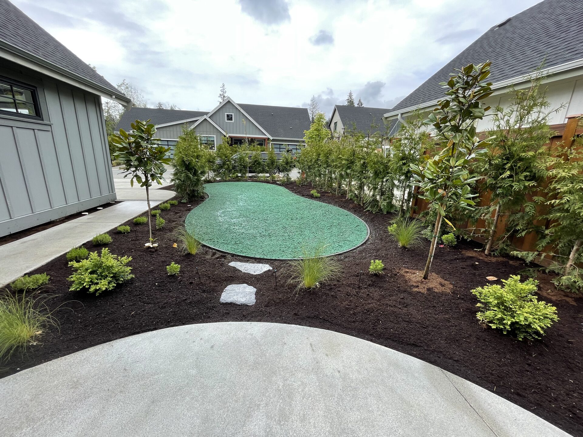 Freshly hydroseeded yard and new garden beds around a newly built home in Courtenay